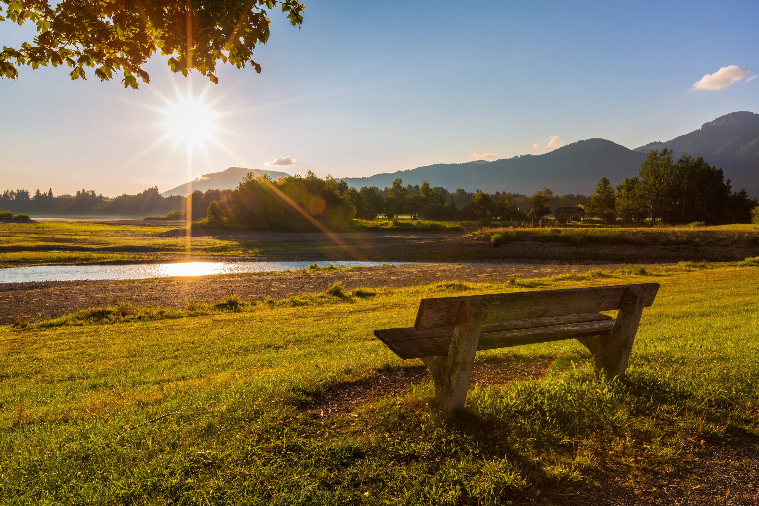 beautiful summer landscape on the sunny morning with the bench on foreground, germany